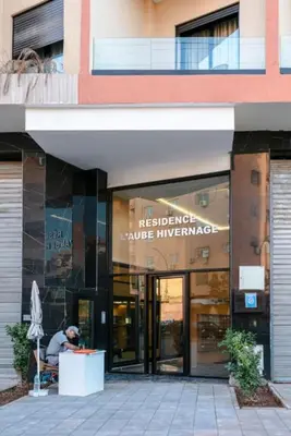 a man sitting in front of a building at The Cozy Corner - Hivernage Marrakech in Marrakech