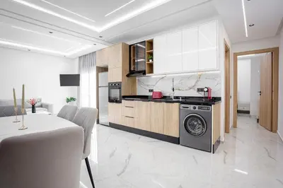 a kitchen with white cabinets and a stove top oven at The Cozy Corner - Hivernage Marrakech in Marrakech