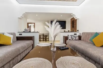 a living room with two couches and a table at Cosy 2BR Appartment, in City Center, AC, Iptv in Marrakech