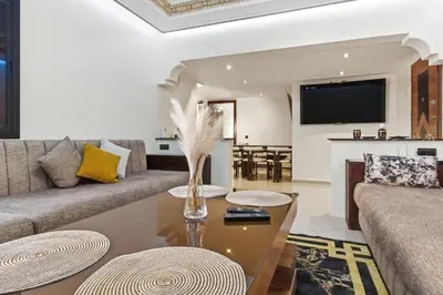 a living room with a couch and a table at Cosy 2BR Appartment, in City Center, AC, Iptv in Marrakech