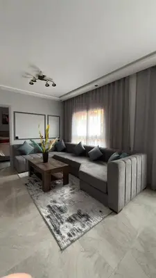 a living room with a couch and a table at Beautiful suite Apartment in the heart of Marrakech in Marrakech