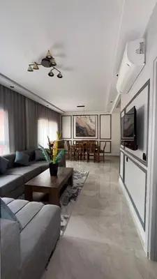 a living room with a couch and a tv at Beautiful suite Apartment in the heart of Marrakech in Marrakech