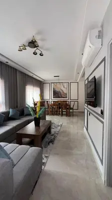 a living room with a couch and a tv at Beautiful suite Apartment in the heart of Marrakech in Marrakech