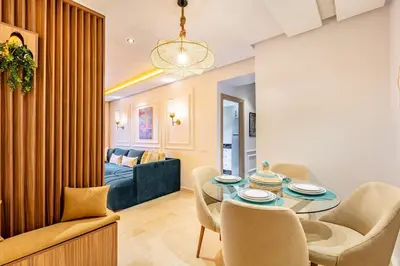 a living room with a table and chairs and a couch at NEW Guéliz I Blue Mirage I Crafts and modernity in Marrakech