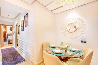 a dining room with a table and chairs and a mirror at NEW Guéliz I Blue Mirage I Crafts and modernity in Marrakech