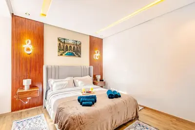 a bedroom with a bed with blue pillows on it at NEW Guéliz I Blue Mirage I Crafts and modernity in Marrakech