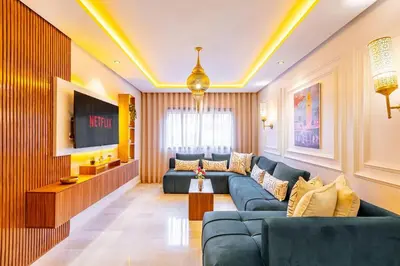 a living room with a couch and a tv at NEW Guéliz I Blue Mirage I Crafts and modernity in Marrakech