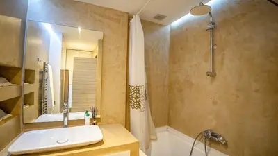 a bathroom with a sink and a tub and a shower at Suites 25, Hivernage, Calme, 2BR, Marrakech in Marrakech