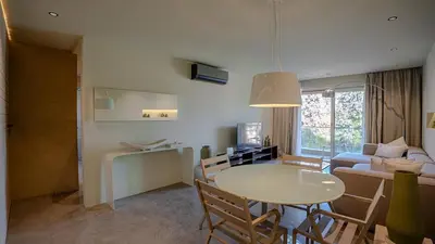 a living room with a table and a couch at Suites 25, Hivernage, Calme, 2BR, Marrakech in Marrakech