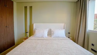 a bedroom with a large bed with white pillows at Suites 25, Hivernage, Calme, 2BR, Marrakech in Marrakech