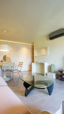 a living room with a glass table and chairs at Suites 25, Hivernage, Calme, 2BR, Marrakech in Marrakech