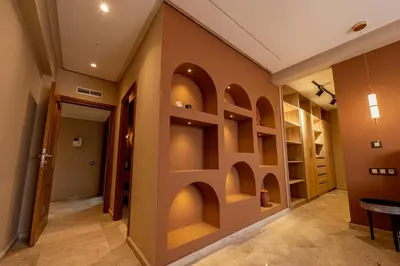 a hallway with arches in the wall at Elegant & Cozy Luxury Apartment Hivernage, Pool City Center in Marrakech