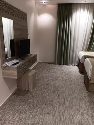 a hotel room with a bed and a mirror at شقة مروان in Marrakech
