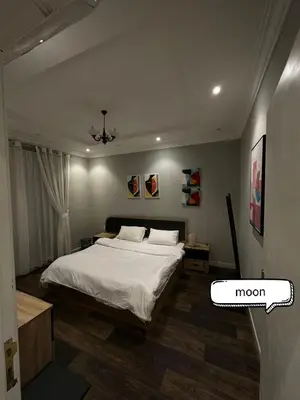a bedroom with a bed and a room with a mogram on it at شقة مروان in Marrakech