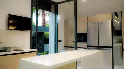 a kitchen with a white counter and a refrigerator at villa argana golf in Marrakech
