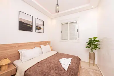 a bedroom with a bed and a potted plant at Red City Elegant Stay in Marrakech