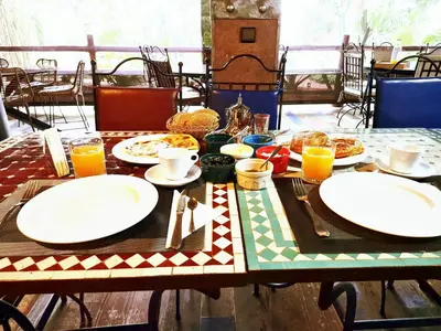 a table with plates of food on top of it at Oasis Of peace Chalet A-frame Atlas view in Aït Amara