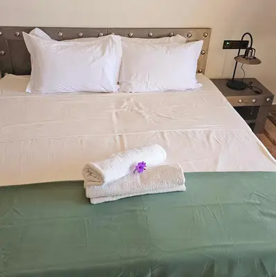 a bed with two towels sitting on top of it at Oasis Of peace Chalet A-frame Atlas view in Aït Amara