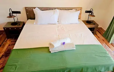 a bedroom with a bed with towels on it at Oasis Of peace Chalet A-frame Atlas view in Aït Amara