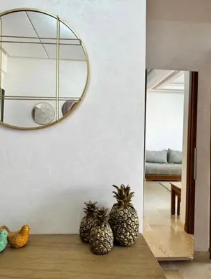 two pineapples sitting on a table under a mirror at Résidence Caricia - WiFi, Piscine, Parking, Gardien h24 in Marrakech