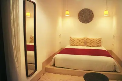 a bedroom with a bed and a large mirror at Dar Helen in Marrakech