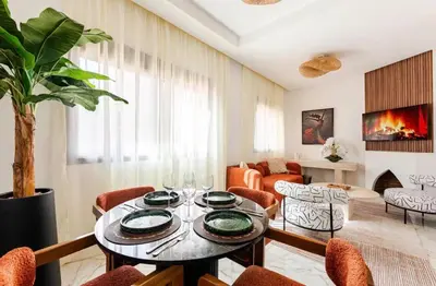 a living room with a table and chairs at Premium Holliday Marrakesh in Marrakech