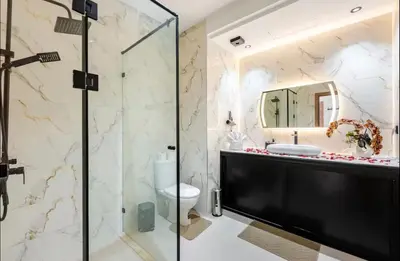 a bathroom with a glass shower and a toilet at Premium Holliday Marrakesh in Marrakech