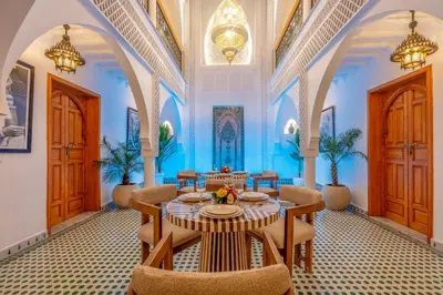 a dining room with a table and chairs at Riad Secret De Medina in Marrakech