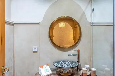 a bathroom with a sink and a mirror at Riad Secret De Medina in Marrakech