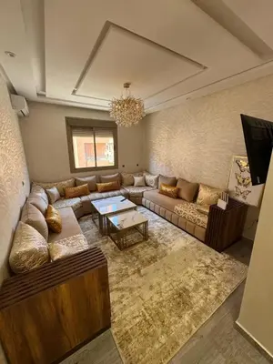 a large living room with a couch and a table at Apparemment cosy pour famille in Marrakech