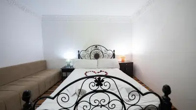 a bedroom with a bed and a couch at Mizo House in Marrakech