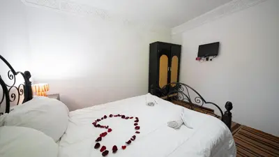 a bed with a bunch of red hearts on it at Mizo House in Marrakech