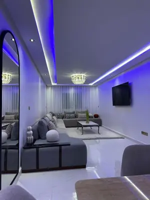 a living room with a couch and a tv at Prestige Gueliz city centre appartement in Marrakech