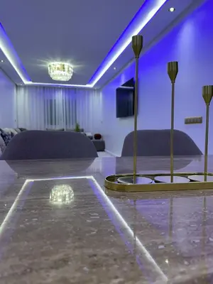 a living room with purple lighting and a table at Prestige Gueliz city centre appartement in Marrakech