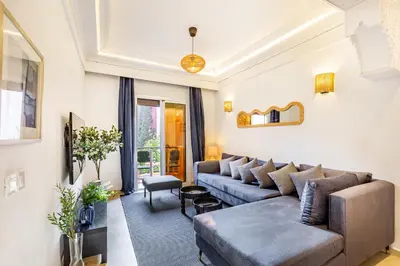 a living room with a couch and a table at Luxe et calme en plein centre de Marrakech in Marrakech