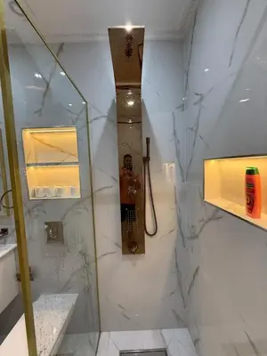 a bathroom with a shower with a clock on the wall at Dar des étoiles in Marrakech