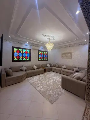 a living room with couches and stained glass windows at Dar des étoiles in Marrakech