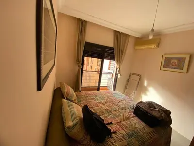 a bedroom with a bed and a window at اقامة كنزي مراكش كليز in Marrakech