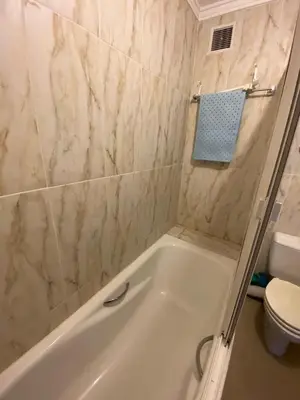 a bathroom with a white tub and a toilet at اقامة كنزي مراكش كليز in Marrakech