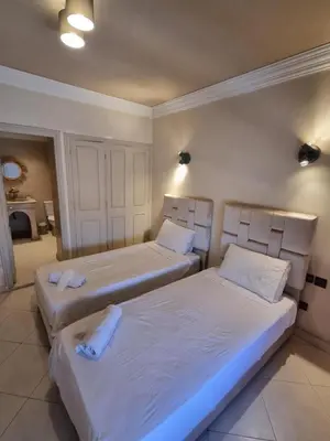 a bedroom with two beds with white sheets at La Boheme City Center Entire Unique Appart 3Bdr 3Bthr in Marrakech