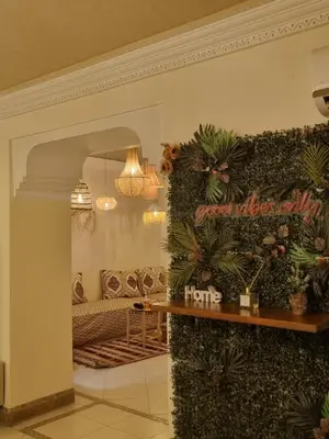 a living room with a couch and plants on a wall at La Boheme City Center Entire Unique Appart 3Bdr 3Bthr in Marrakech