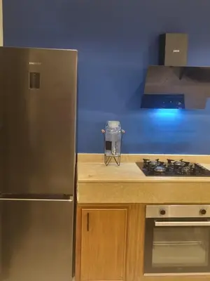 a kitchen with a stainless steel refrigerator and a stove at La Boheme City Center Entire Unique Appart 3Bdr 3Bthr in Marrakech