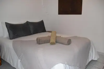 a bed with two brown objects on top of it at Riad authentique dans une résidence sécurisée in Marrakech
