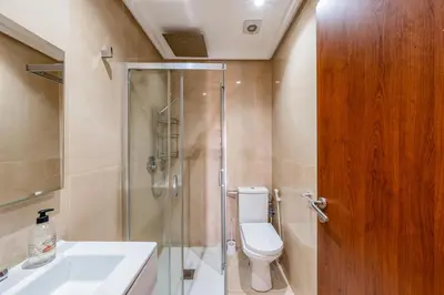 a bathroom with a shower and a toilet and a sink at Sunny Getaway with Pool Access & Private Yard in Marrakech