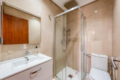 a bathroom with a shower and a sink and a toilet at Sunny Getaway with Pool Access & Private Yard in Marrakech