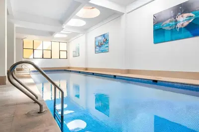 an indoor swimming pool with a blue swimming pool at White Oasis Swimming pool and Design in Marrakech