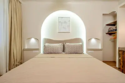 a bedroom with a bed in an arched room at White Oasis Swimming pool and Design in Marrakech
