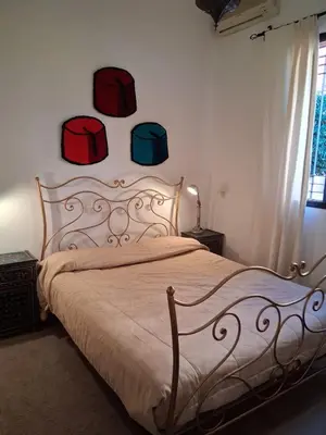 a bedroom with a bed with four boxes on the wall at Casa Rosa in Marrakech