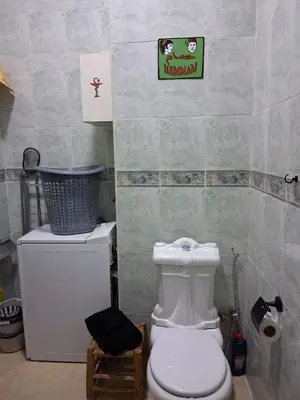 a bathroom with a toilet and a sign on the wall at Casa Rosa in Marrakech