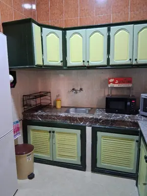 a kitchen with green cabinets and a sink at Casa Rosa in Marrakech